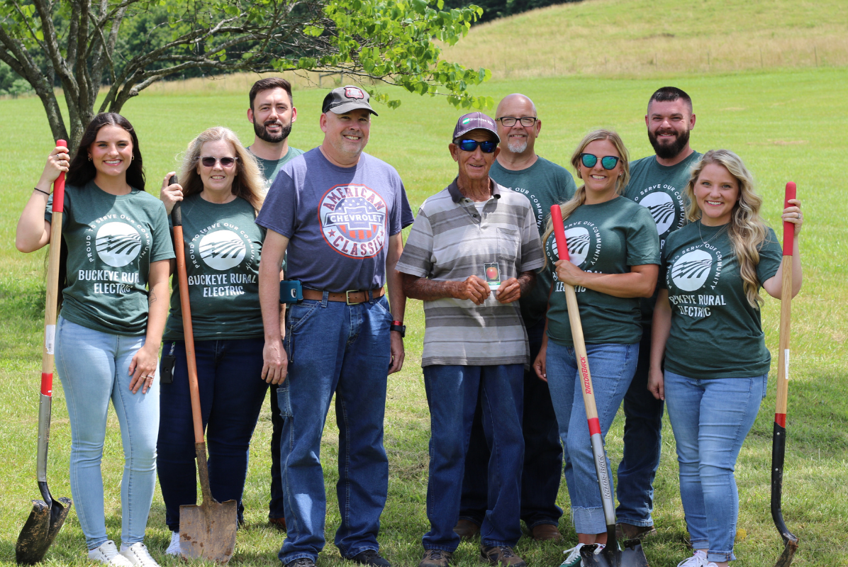 Group of people posing after planting trees